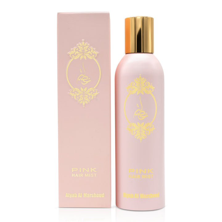 Light pink body essence bottle with a gold cap standing next to its matching pink product box featuring gold floral design.
