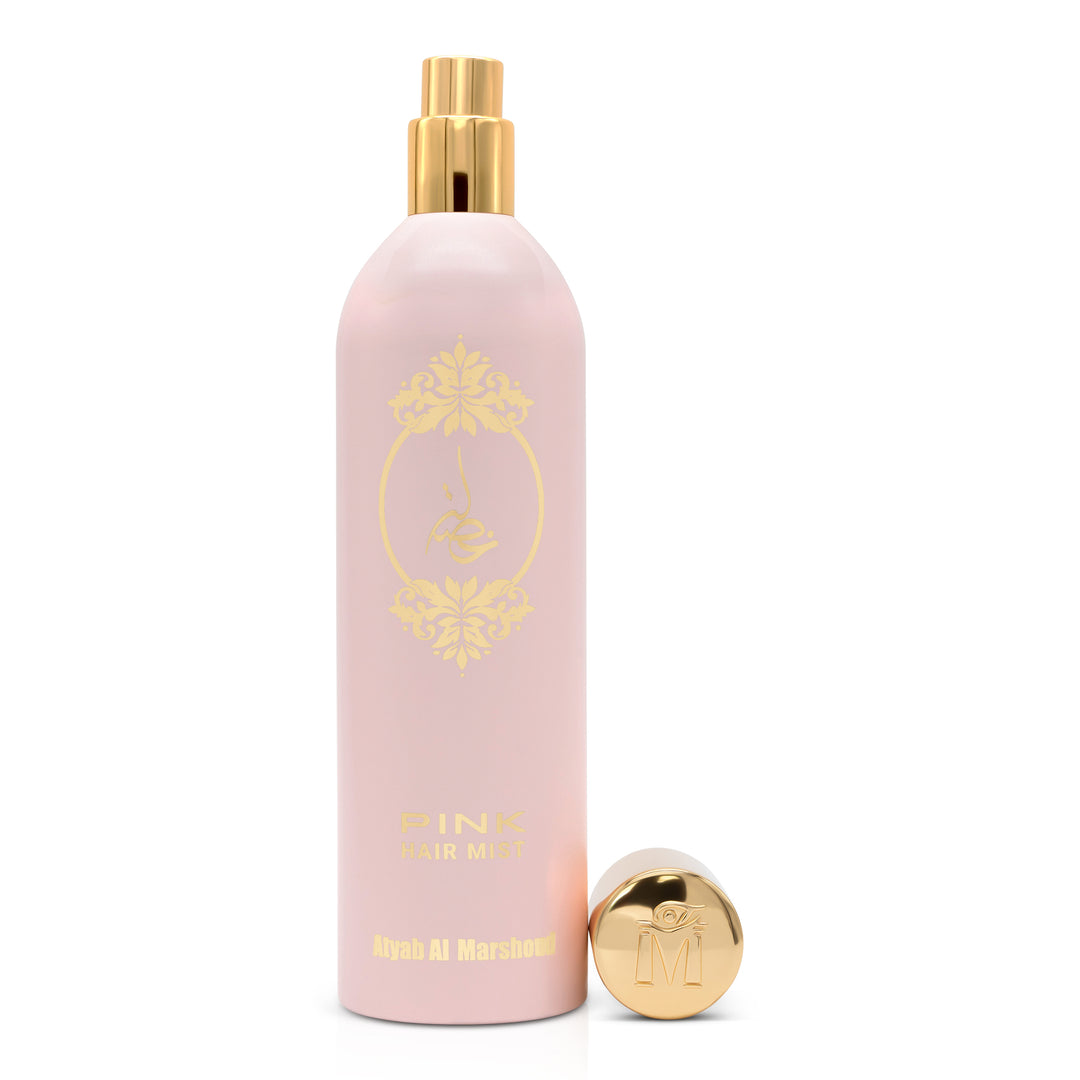 Light pink body essence bottle with its gold cap removed, showing the spray nozzle on a white background.